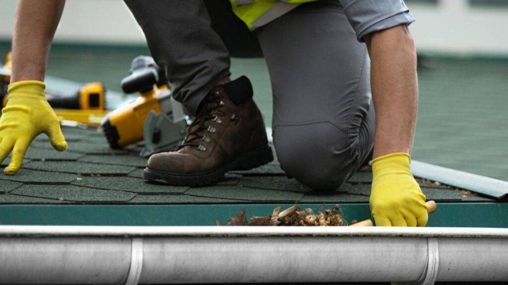 gutter inspection Florida technician checking gutters on a home before hurricane season