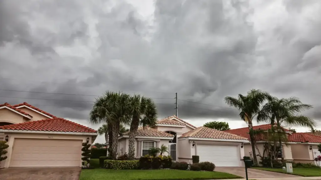 Hurricane gutter preparation Florida storm clouds over home with secure gutter system